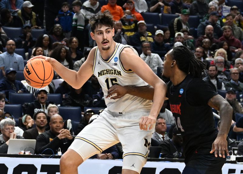 Michigan’s Aday Mara works against Howard University’s Bryce Harris in the first half of the first round of the NCAA Tournament (East Region) at Key Bank Center, in Buffalo, New York on March 19, 2026.