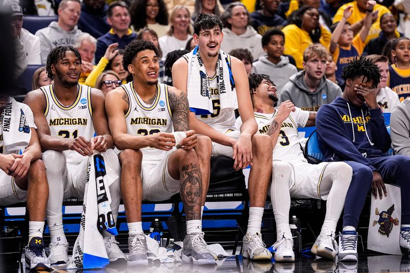 From left, Michigan players forward Morez Johnson Jr. (21), forward Yaxel Lendeborg (23), center Aday Mara (15) and guard Elliot Cadeau (3), guard L.J. Cason (2) watch the last seconds of the game against Howard from bench at the NCAA Tournament First Round at KeyBank Center in Buffalo on Thursday, March 19, 2026.