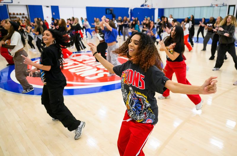 Talia Smith, right, warms up alongside about 100 other current and former Detroit Pistons Dancers as they rehearse a special routine to be performed the following day in celebration of the organization’s 30th anniversary, on Thursday, March 19, 2026 at the Detroit Pistons Performance Center in Detroit.