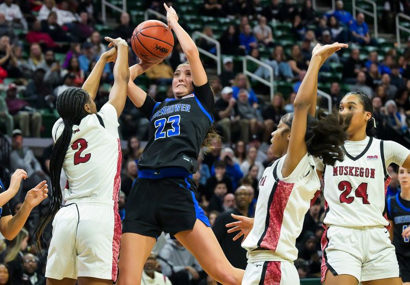 Utica Eisenhower’s Gabriella Gojcaj takes a shot while Muskegon’s Jamiyah Ezell guards her during their Div. 1 state semifinal on Friday, March 20, 2026 at the Breslin Center in East Lansing.