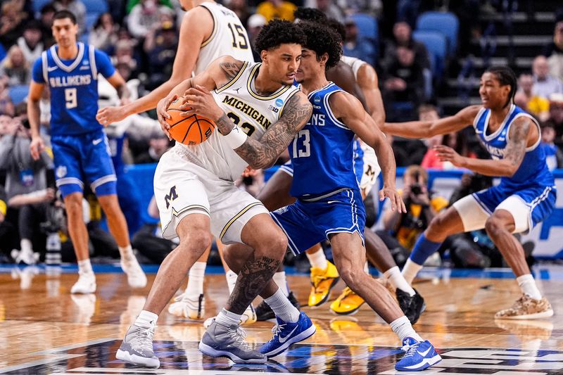 Michigan forward Yaxel Lendeborg (23) dribbles against Saint Louis guard Dion Brown (13) during the first half of NCAA Tournament Second Round at KeyBank Center in Buffalo on Saturday, March 21, 2026.