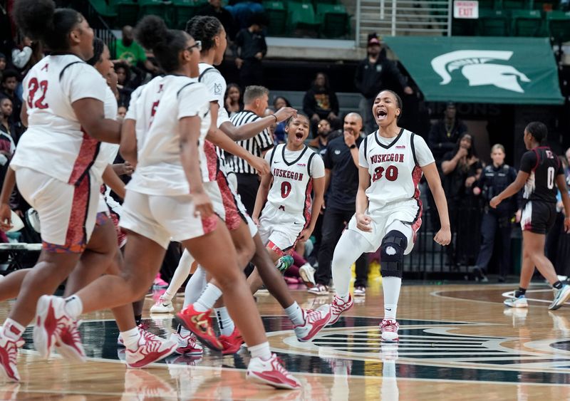 Muskegon (30) Jaila Martin yells and celebrates with her teammates after beating Detroit Renaissance 34-29 n the MHSAA Division 1 girls basketball finals between at the Breslin Center in East Lansing on Saturday, March 21, 2026.
