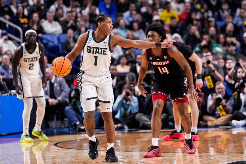Michigan State guard Jeremy Fears Jr. (1) looks to pass against Louisville guard Adrian Wooley (14) during the first half of NCAA Tournament Second Round at KeyBank Center in Buffalo on Saturday, March 21, 2026.