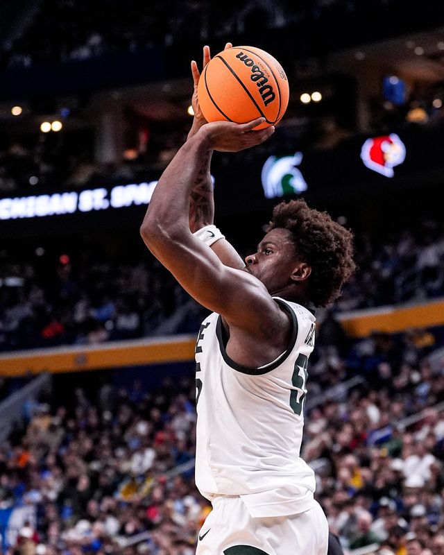 Michigan State forward Coen Carr (55) shoots a 3-pointer against Louisville during the second half of NCAA Tournament Second Round at KeyBank Center in Buffalo on Saturday, March 21, 2026.