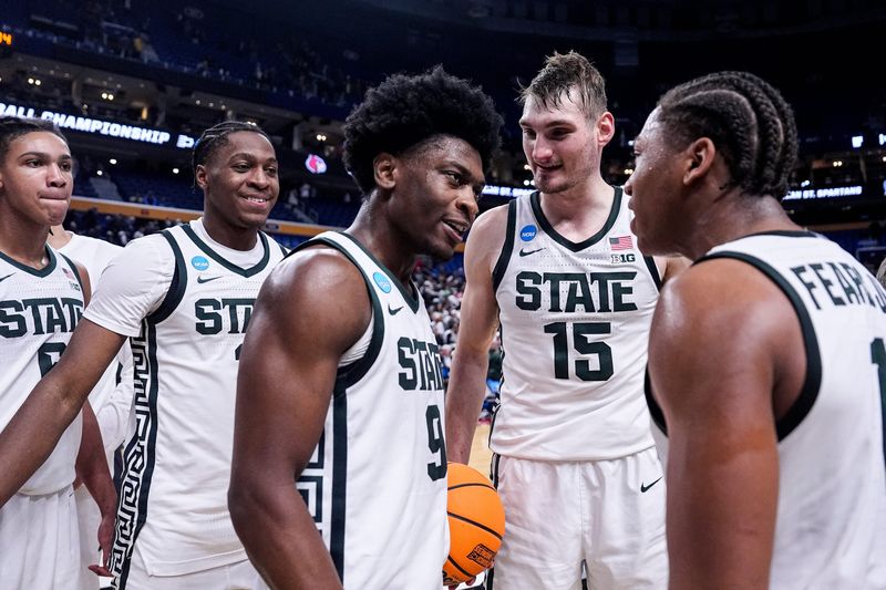 Michigan State guard Trey Fort (9), center left, and guard Jeremy Fears Jr. (1) celebrates 77-69 win over Louisville at the NCAA Tournament Second Round at KeyBank Center in Buffalo on Saturday, March 21, 2026.