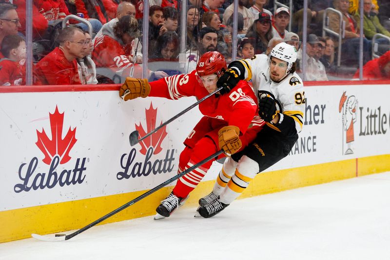 Detroit Red Wings defenseman Moritz Seider and Boston Bruins center Marat Khusnutdinov fight for control of the puck during the third period at Little Caesars Arena on Saturday night.