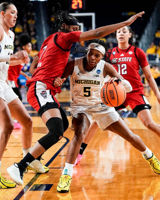 Michigan guard Brooke Q. Daniels (5) dribbles against N.C. State guard Destiny Lunan (7) during the first half of NCAA Tournament Second Round at Crisler Center in Ann Arbor on Sunday, March 22, 2026.