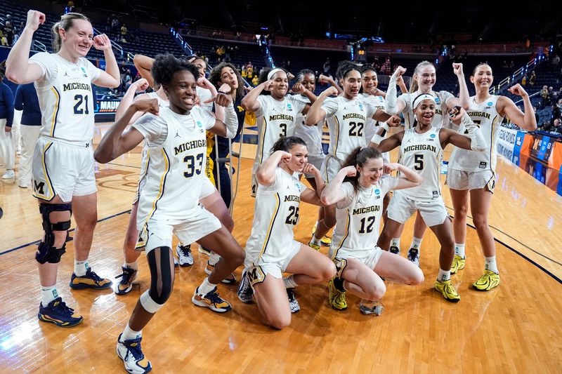Michigan players and coaches celebrate 92-63 win over N.C. State at the NCAA Tournament Second Round at Crisler Center in Ann Arbor on Sunday, March 22, 2026.