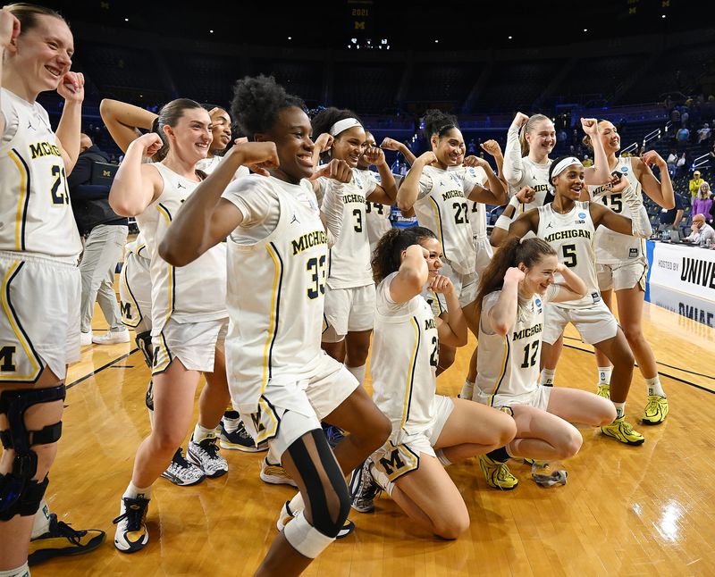 Michigan players pose for a photo after their 92-63 win over NC State in the 2026 NCAA Division Women’s Basketball Championship Second Round at Crisler Center on Sunday, March 22, 2026, in Ann Arbor, Mich.