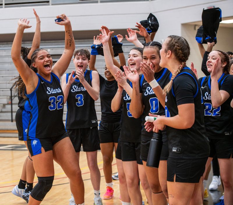 Lansing Community College basketball team celebrates after beating Schoolcraft in the Stars' final game at the NJCAA Division II National Championships in Hickory, North Carolina.