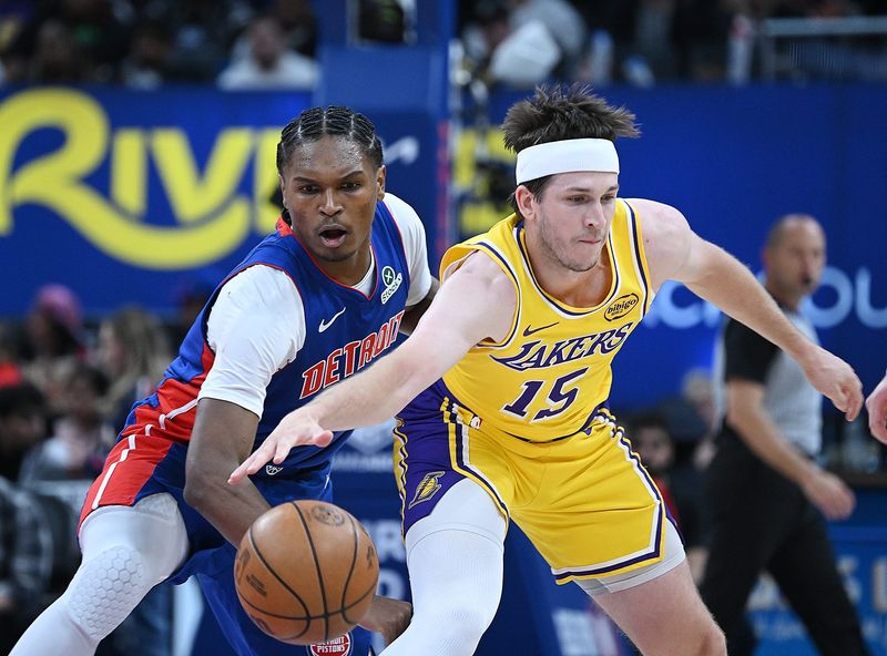 Detroit Pistons guard/forward Ausar Thompson (9) knocks the ball from Los Angeles Lakers guard Austin Reaves (15) in the first half. Detroit Pistons vs Los Angeles Lakers, at Little Caesars Arena on Monday, March 23, 2026, in Detroit, Mich.