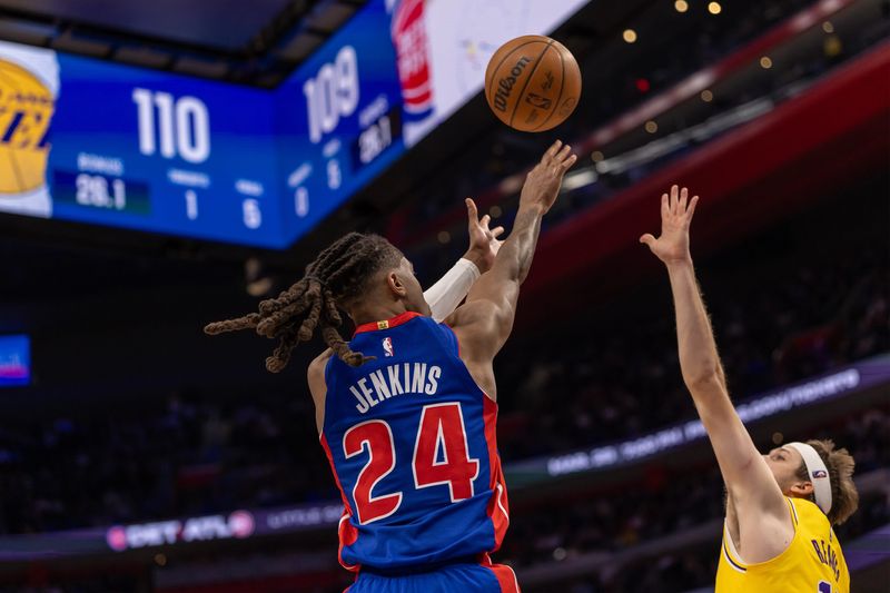 Detroit Pistons Daniss Jenkins (24) shoots a big two point basket late in fourth quarter as Los Angeles Lakers Austin Reaves (15) defends at Little Caesars Arena in Detroit on Monday, March 23, 2026.