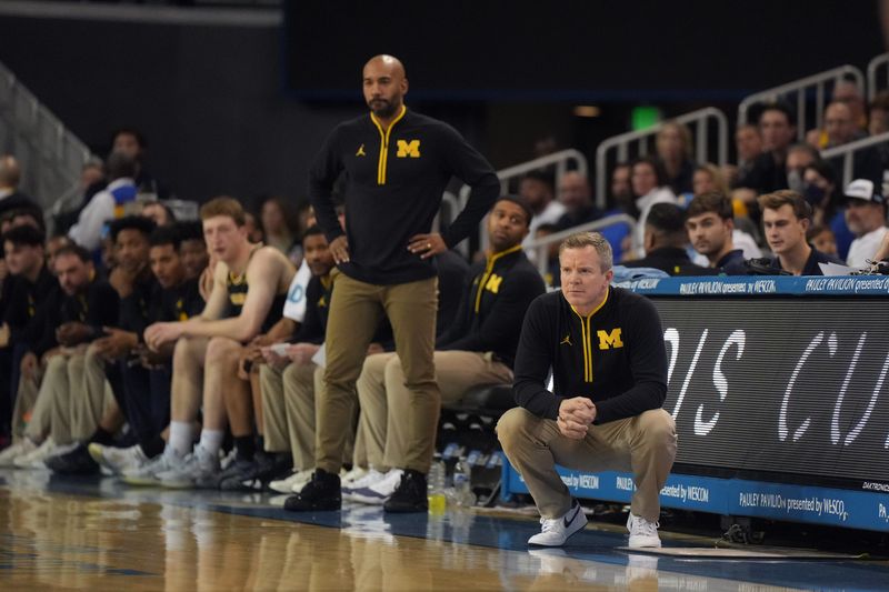 Justin Joyner (left) is continuing his coaching role with Michigan during March Madness while also being onboarded as Oregon State's new head coach.
