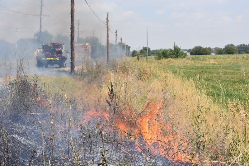A grass fire burns along Larimer County Road 5 just north of Timnath in this June 2020 photo.