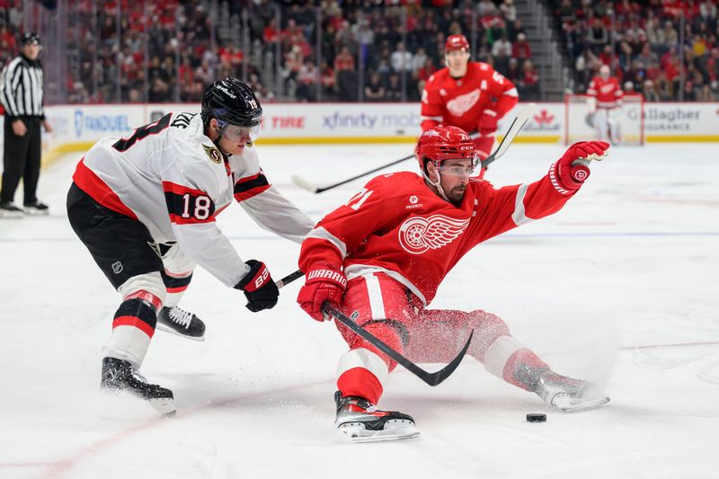Detroit center Dylan Larkin is tripped up by Ottawa center Tim Stützle but no penalty was called during the first period of a game between the Detroit Red Wings and the Ottawa Senators at Little Caesars Arena, in Detroit, March 24, 2026.