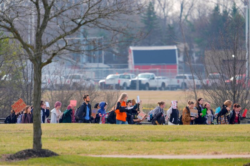 Some of the over 50 students from the Plymouth-Canton Community Schools walked out of the three schools on the campus to protest ICE during a march around the bus loop behind Salem High School in Canton on Wednesday, March 25, 2026.