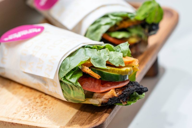 The sweet heat chicken ranch sandwich made with herb-roasted chicken, roasted sweet potato, truffle buttermilk ranch, hot sauce, tomatoes, cucumbers, sweet pickles, baby spinach, wrapped in swiss chard made by Breadless that will be sold during the season is on display during the 2026 “What’s New at Comerica Park” annual media event at Comerica Park in Detroit on Wednesday, March 25, 2026.