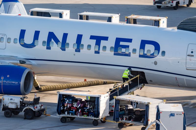 Luggage is unloaded from a United Airlines plane on March 11, 2026, in West Palm Beach, Florida.