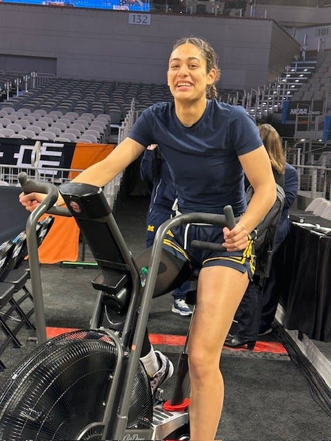 Macy Brown works out on an exercise bike on Friday in Fort Worth, Texas, where Michigan will play Louisville on Saturday.
