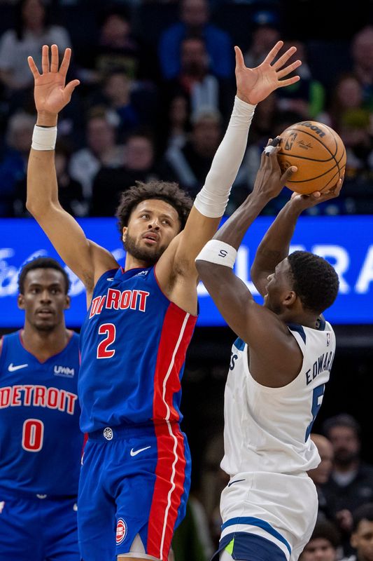 Detroit Pistons guard Cade Cunningham defends Minnesota Timberwolves guard Anthony Edwards in the second half at Target Center, March 27, 2024, in Minneapolis.