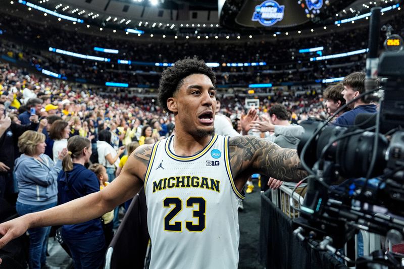 Michigan forward Yaxel Lendeborg (23) high-fives fans to celebrate 90-77 win over Alabama at the NCAA Tournament Sweet 16 round at United Center in Chicago on Friday, March 27, 2026.