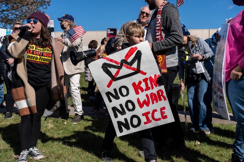 Grayson Hunter, 10, holds a sign reading “No kings, no war, no ICE” during a No Kings protest in Romulus on Saturday, March 28, 2026. ICE has announced plans to open a detention center in the city, and some residents have expressed opposition.