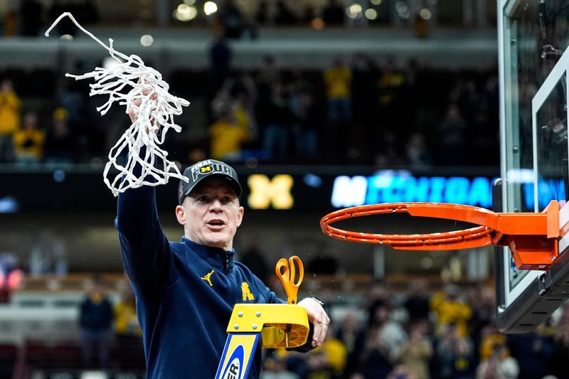 Michigan coach Dusty May celebrates after winning the NCAA Tournament Midwest Regional Champion by defeating Tennessee 95-62 rat United Center in Chicago on Sunday, March 29, 2026.