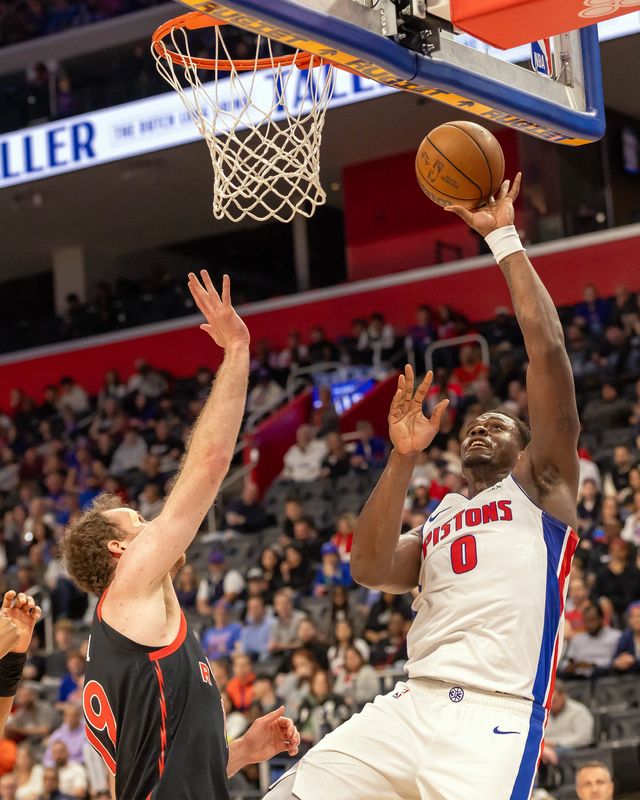 Detroit Pistons center Jalen Duren (0) goes to the basket for two points against Toronto Raptors Jakob Poeltl (19) during the first quarter at Little Caesars Arena in Detroit on Tuesday, March 31, 2026.