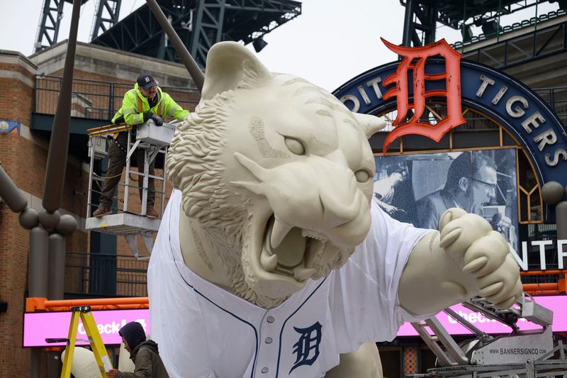Install manager Ken Blaznek, uses a crane to install a giant sized jersey onto the tiger statue outside Comerica Park in preparation for opening day, in Detroit, April 2, 2026.