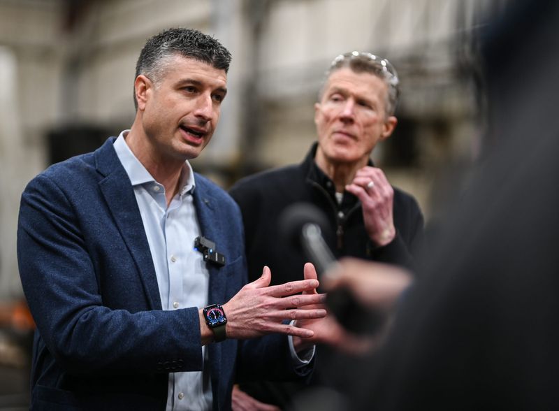 U.S. Rep. Tom Barrett, R-Potterville, left, speaks to members of the press, Thursday, April 2, 2026, during a tour of Cambell Press near Lansing's REO Town in Lansing, as Peter Campbell of Campbell Press looks on.