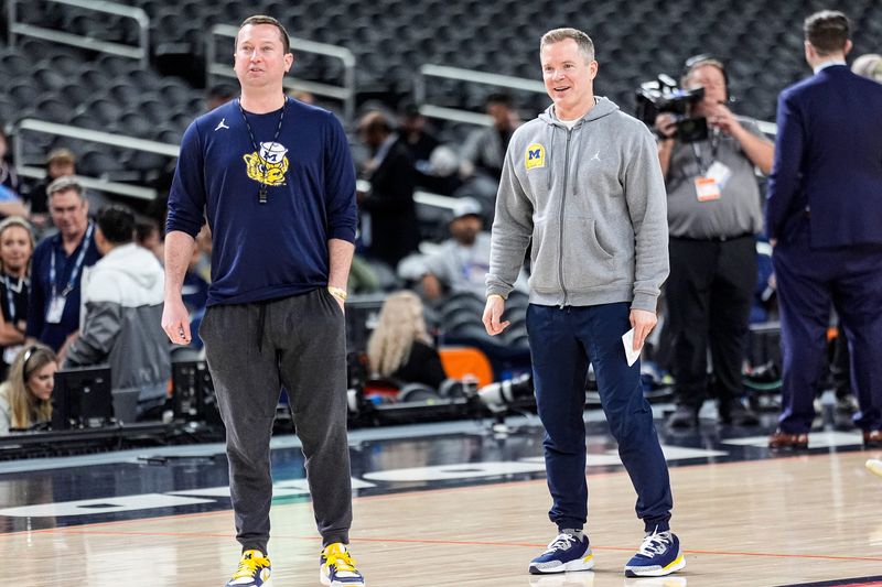 Michigan head coach Dusty May and assistant coach and general manager Kyle Church watch open practice at Lucas Oil Stadium in Indianapolis on Friday, April 3, 2026.