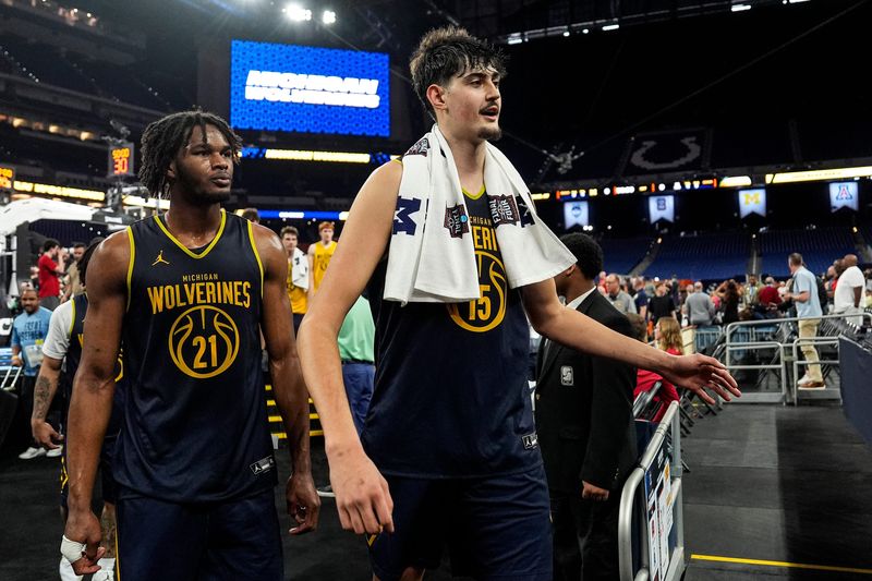 Michigan center Aday Mara (15), center, and forward Morez Johnson Jr. (21), left, walk off the court after open practice at Lucas Oil Stadium in Indianapolis on Friday, April 3, 2026.