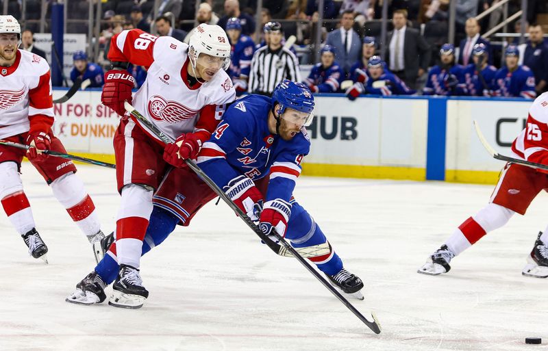 Apr 4, 2026; New York, New York, USA; Detroit Red Wings right wing Patrick Kane and New York Rangers defenseman Vladislav Gavrikov battle for the puck during the second period at Madison Square Garden.