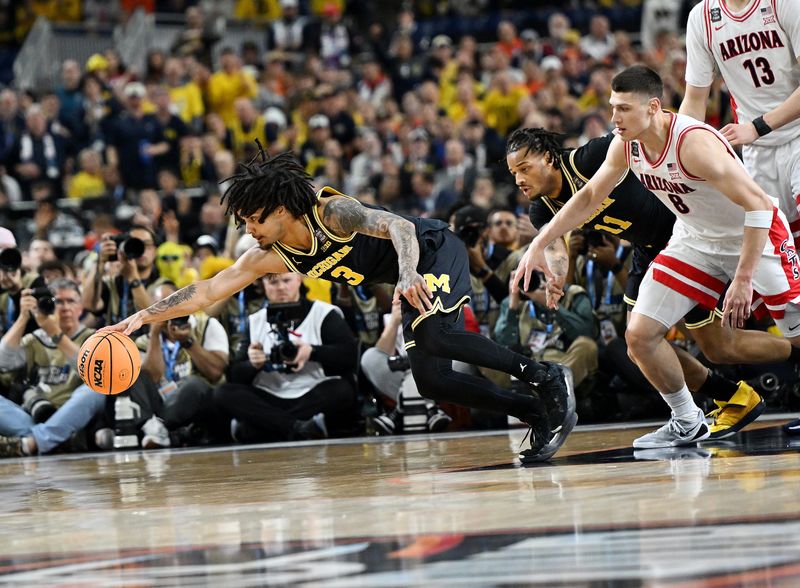 Michigan guard Elliot Cadeau (3) makes a steal in front of Arizona forward Ivan Kharchenkov (8) in the first half as Michigan takes on Arizona in the NCAA men’s basketball championship semifinal at Lucas Oil Stadium on April 4, 2026 in Indianapolis.