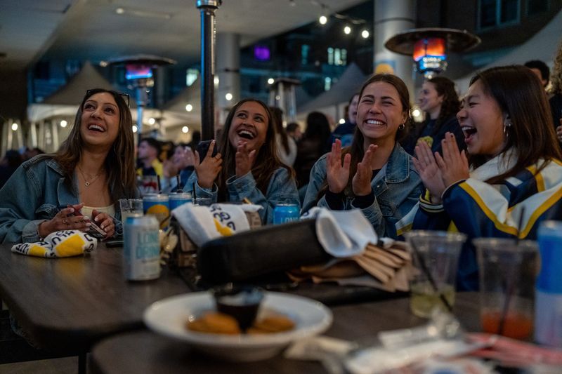 Fans celebrate as they watch the Michigan Wolverines take on the Arizona Wildcats during the NCAA men’s basketball tournament Final Four inside The Garage Bar in Ann Arbor on Saturday, April 4, 2026.