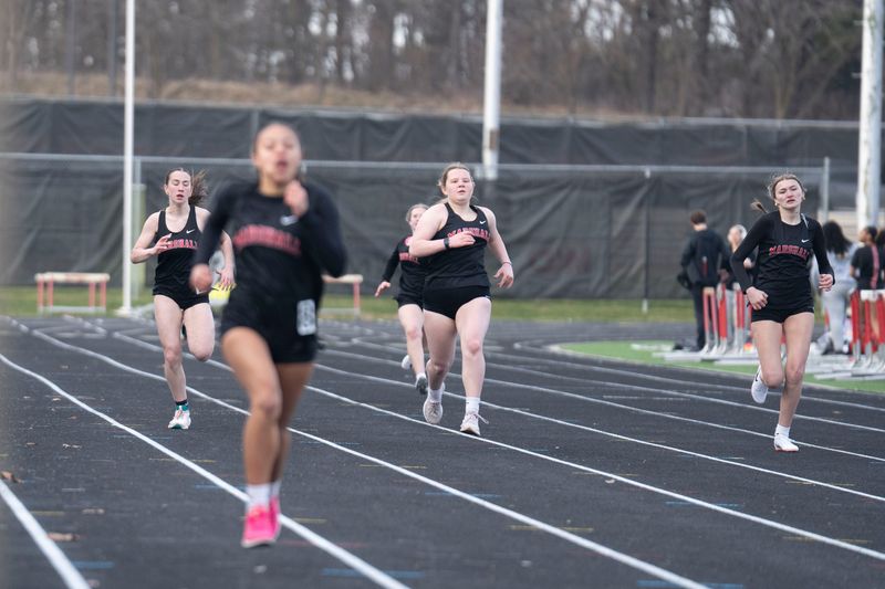 Marshall runners approach the finish line during a meet at Marshall High School on Friday, March 24, 2026.