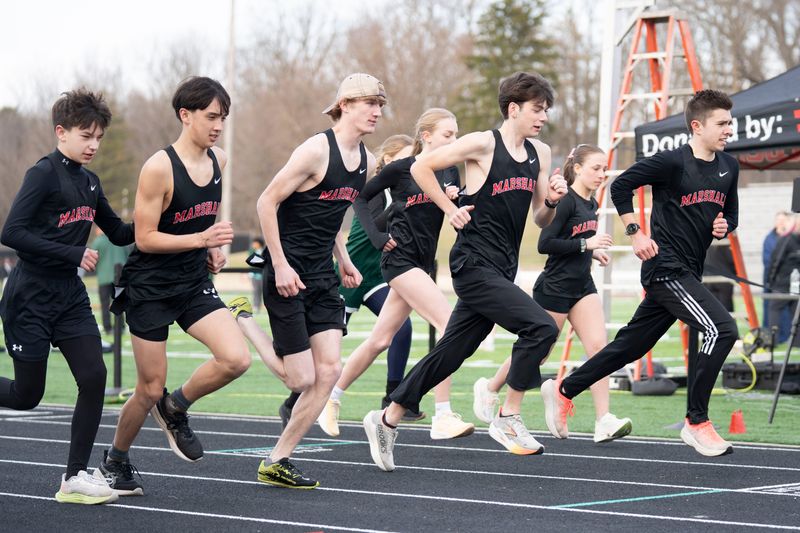 Runners take off from the starting line for the 3200 meter race during a meet at Marshall High School on Friday, March 24, 2026.
