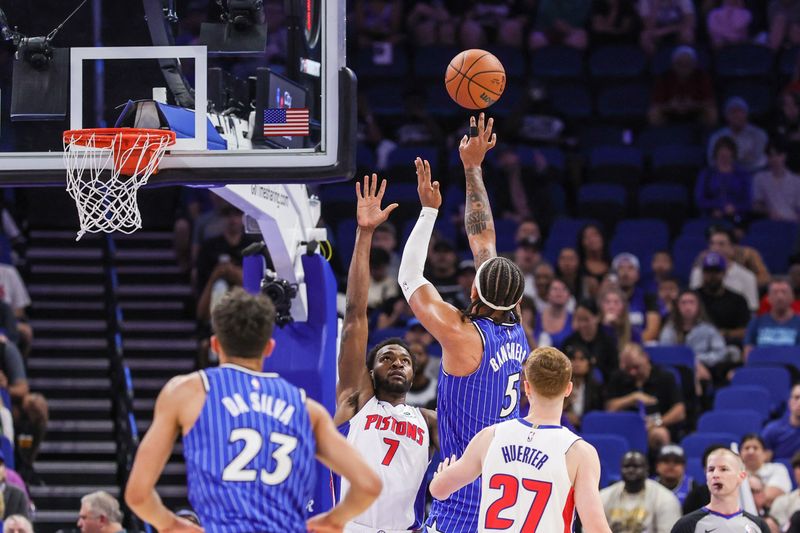 Apr 6, 2026; Orlando, Florida, USA; Orlando Magic forward Paolo Banchero (5) shoots against Detroit Pistons forward Paul Reed (7) during the first quarter at Kia Center. Mandatory Credit: Mike Watters-Imagn Images