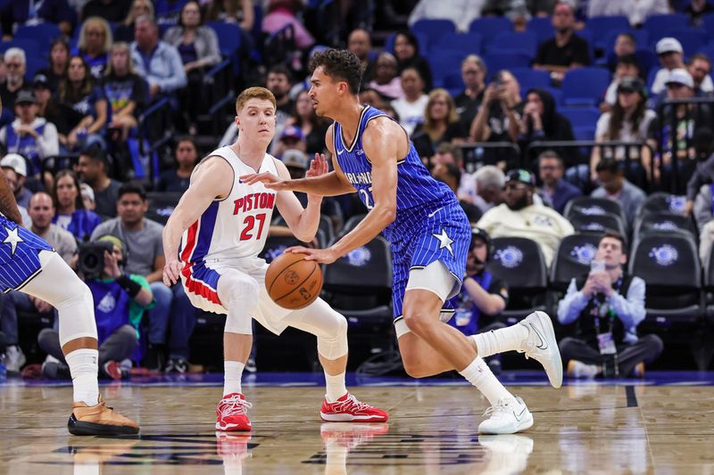 Orlando Magic forward Tristan da Silva (23) drives around Detroit Pistons guard Kevin Huerter (27) during the first quarter at Kia Center in Orlando on Monday, April 6, 2026.