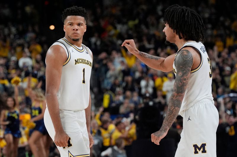 Michigan Michigan guard Trey McKenney (1) and guard Elliot Cadeau (3) react to a play during the second half of the NCAA national championship game against Connecticut at Lucas Oil Stadium in Indianapolis on Monday, April 6, 2026.