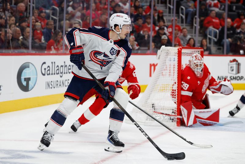 Blue Jackets defenseman Zach Werenski (8) skates with the puck in the first period against the Red Wings at Little Caesars Arena.