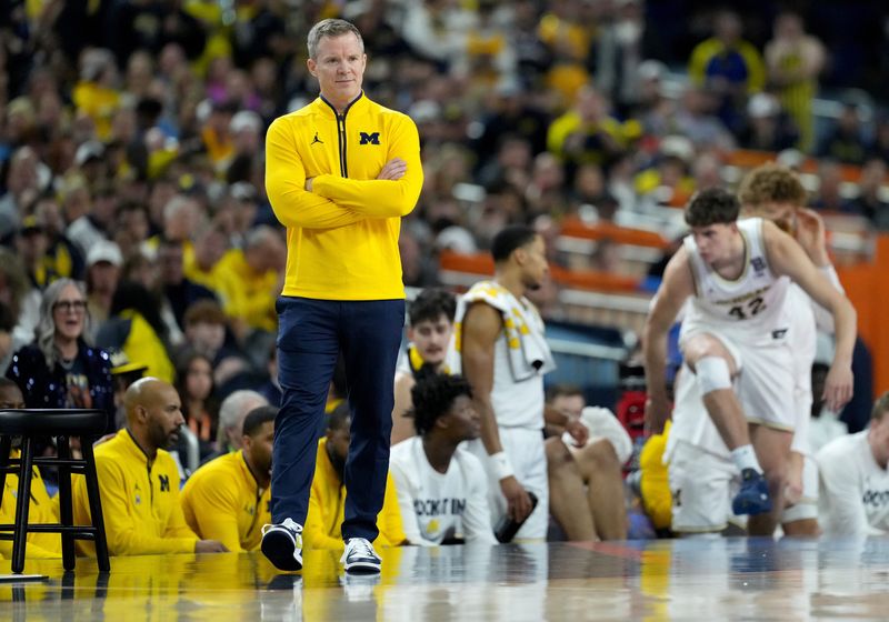 Michigan Wolverines head coach Dusty May walks the sideline Monday, April 6, 2026, during the NCAA men's basketball tournament national championship game against the UConn Huskies at Lucas Oil Stadium in Indianapolis.