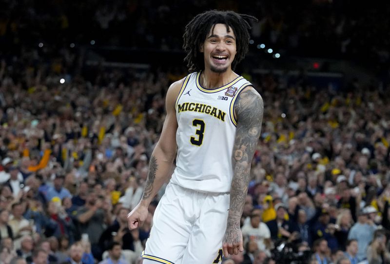 Michigan Wolverines guard Elliot Cadeau (3) celebrates the teamâ€™s NCAA men's basketball tournament national championship victory Monday, April 6, 2026, after defeating the UConn Huskies 69-63 at Lucas Oil Stadium in Indianapolis.