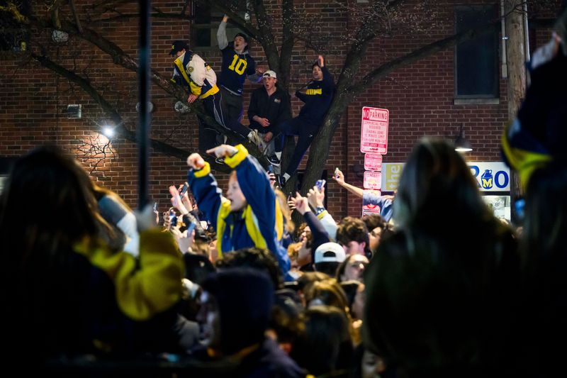 Michigan students flood the intersection of S. University Ave. and Church Street in downtown Ann Arbor to celebrate Michigan basketball’s 69-63 NCAA championship win over UConn on Monday, April 6, 2026.