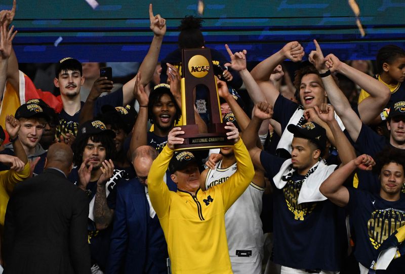 Michigan head coach Dusty May and the Wolverines celebrate a 69-63 victory over UConn in the NCAA Final in Indianapolis, Indiana on April 6, 2026.