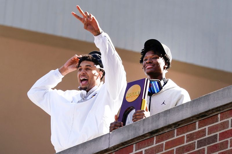 Michigan forward Yaxel Lendeborg (23) and guard L.J. Cason (2) wave to fans on Tuesday, April, 7, 2026, at Crisler Center after the team arrived home after winning the NCAA national championship, 69-63, against Connecticut.