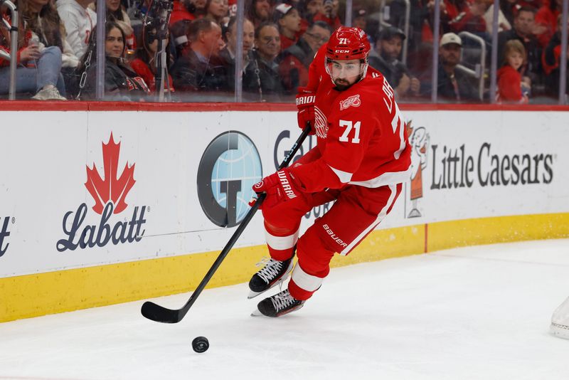 Detroit Red Wings center Dylan Larkin (71) skates with the puck in the first period against the Columbus Blue Jackets at Little Caesars Arena in Detroit on Tuesday, April 7, 2026.