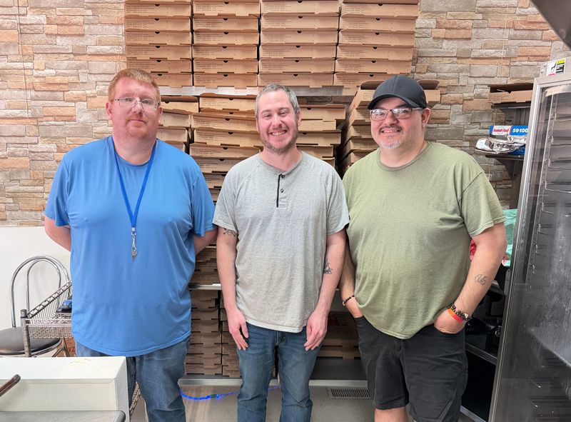 From left, Mark White, TJ MacDormott and Thomas Enright stand inside No Crumbs Pizza and More, 1319 Gratiot Blvd., Marysville, on April 8, 2026.
