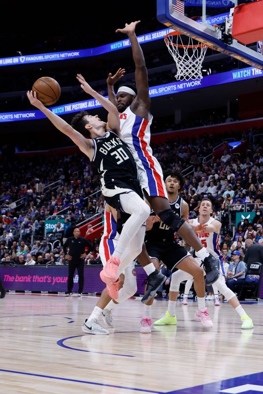 Milwaukee Bucks guard Cormac Ryan attempts a layup against Detroit Pistons forward Isaiah Stewart in the second half at Little Caesars Arena in Detroit on April 8, 2026.