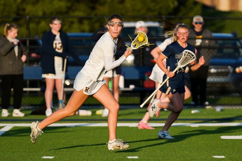 Hartland’s Amanda Norton cradles the ball down the field during a game against Detroit Country Day on Wednesday, April 8, 2026 in Hartland.
